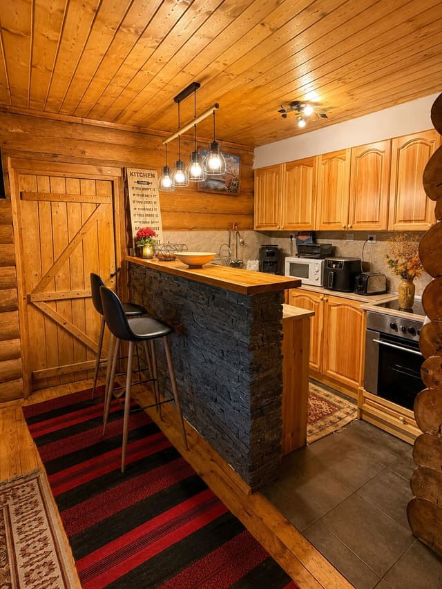 Ground-floor kitchen with a bar counter and bar stools